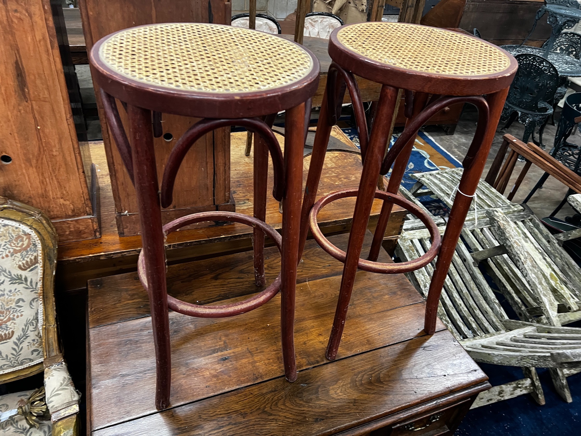 A pair of caned bentwood bar stools, height 76cm